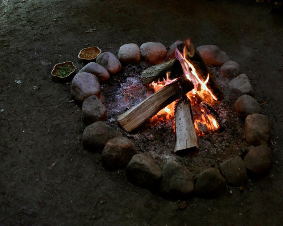 Alternative healing through sacred fire sharing circles. A photo of a fire inside a tipi.